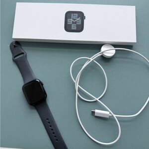 Apple Watch with Black Sport Band and White Magnetic Charger